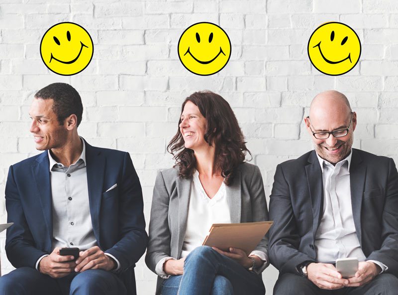 3 business people smiling with smiley face above heads