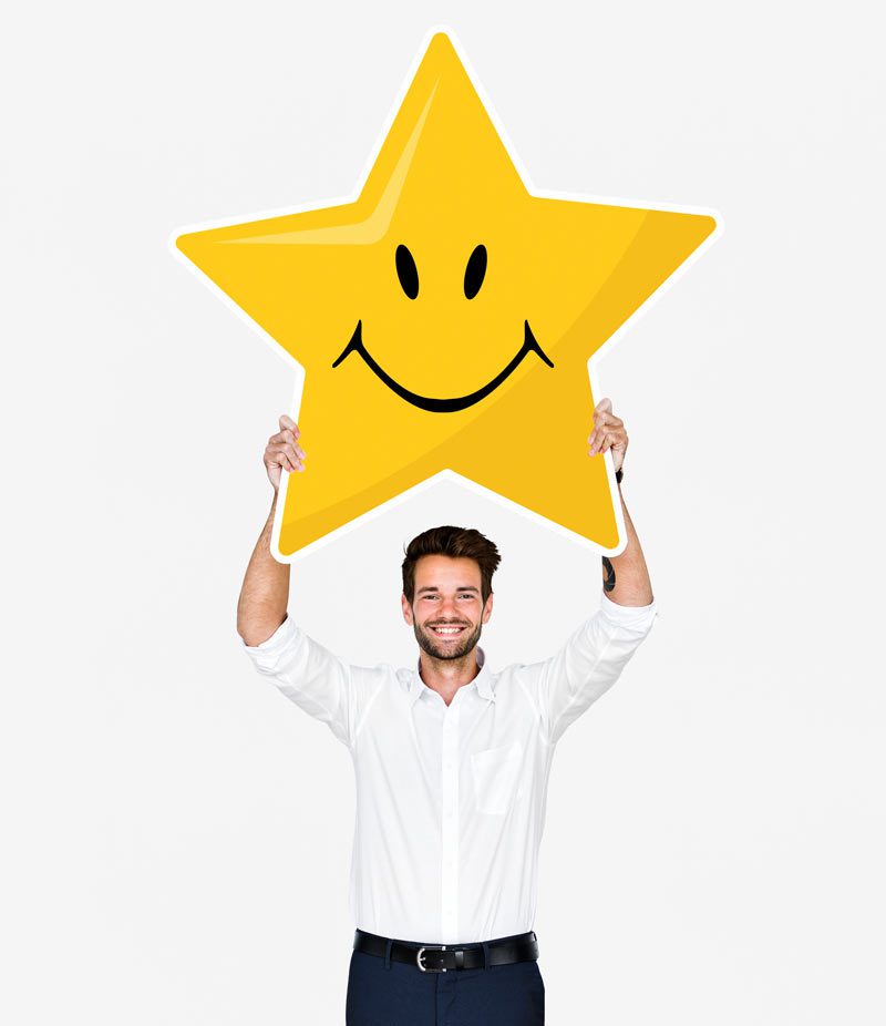 business man holding up star sign with smiley face