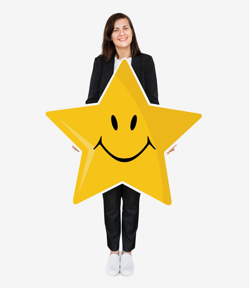 smiling business woman holding star with smiley face